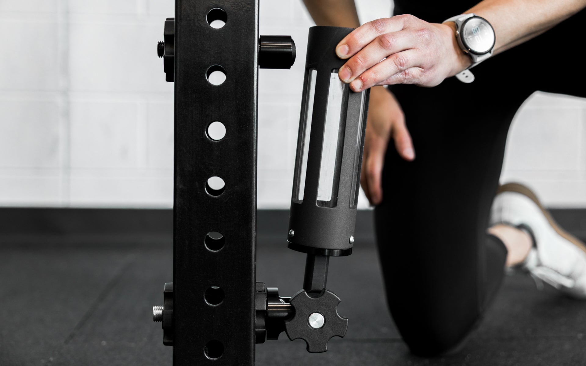 An athlete attaching the base of the Rack Mounted REP® x Kleva Built® Adroit Landmine to the magnetic top piece