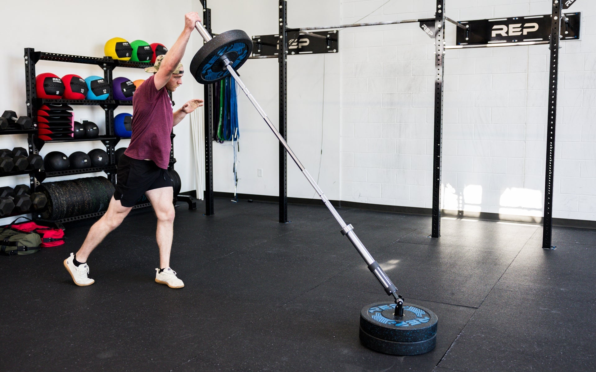 An athlete performing standing presses with the Free Standing REP® x Kleva Built® Adroit Landmine